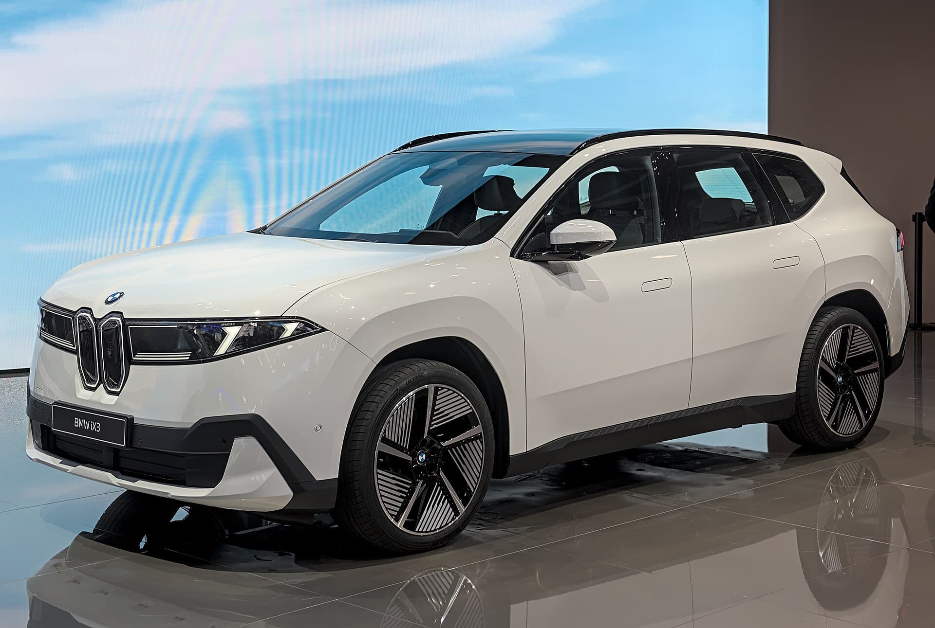 Grey BMW iX3 Neue Klasse battery SUV on the IAA 2025 stand, front three-quarter view