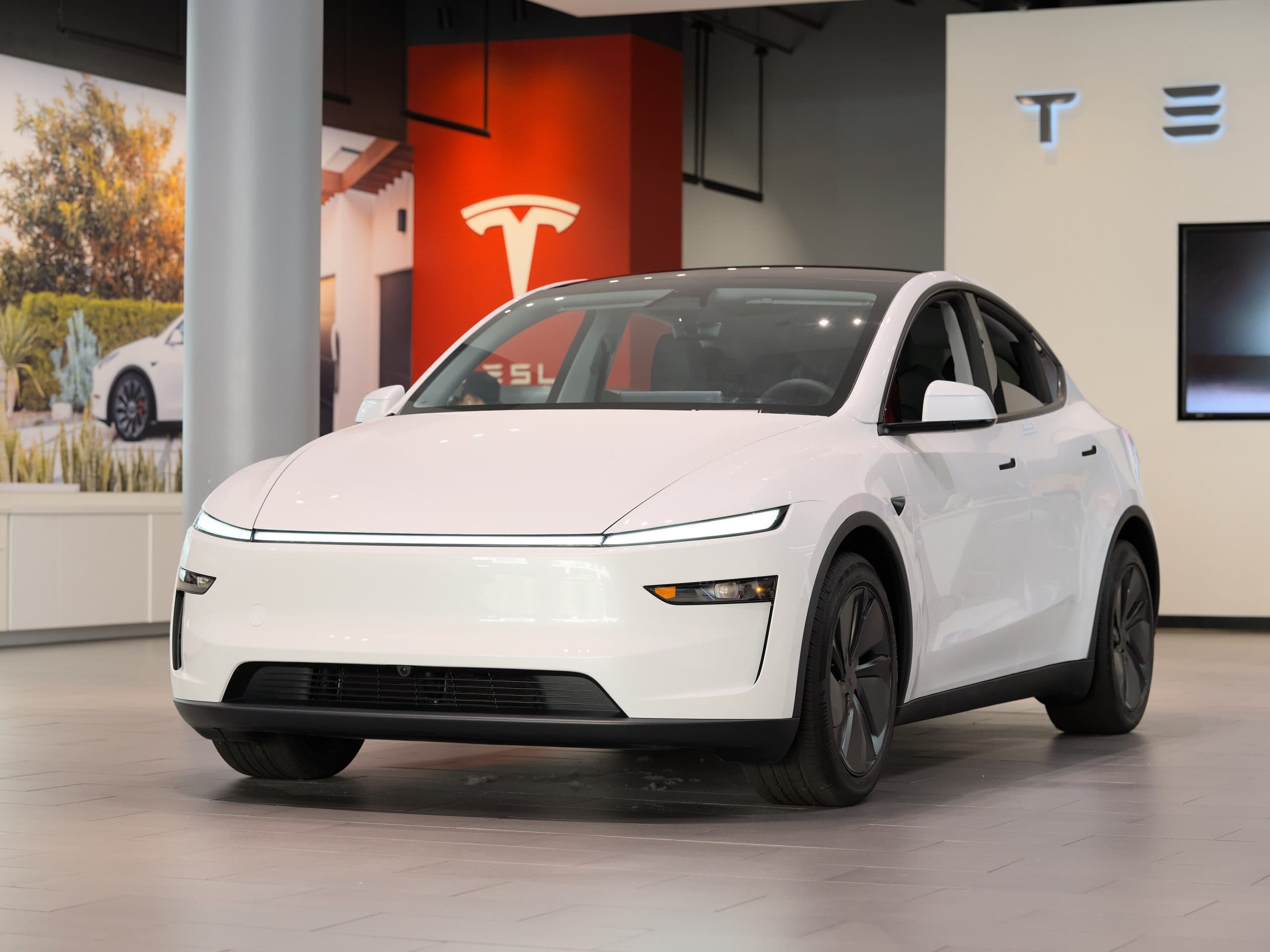 White Tesla Model Y battery SUV, front three-quarter view