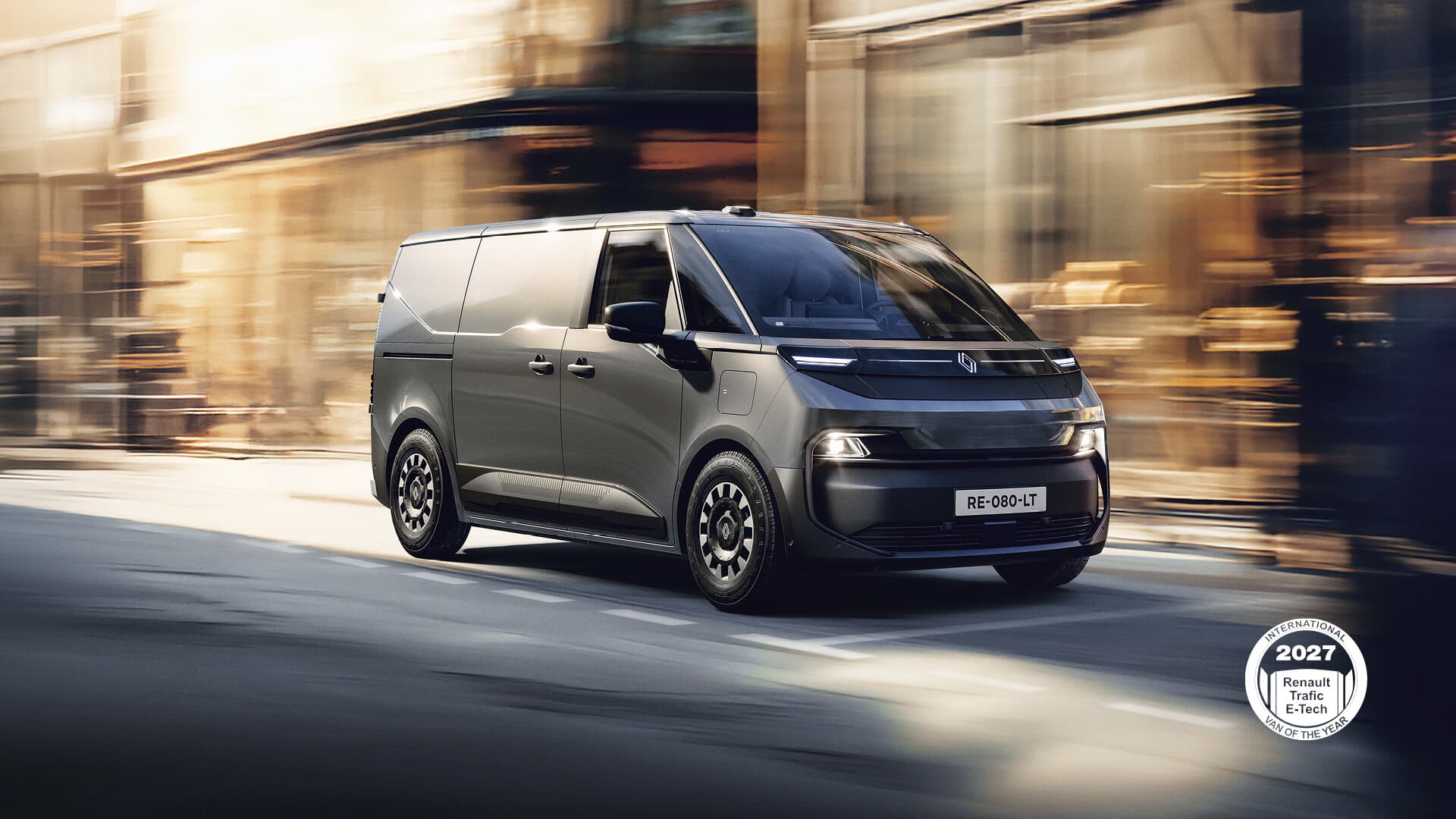Grey Renault Trafic Van E-Tech electric van driving on a city street