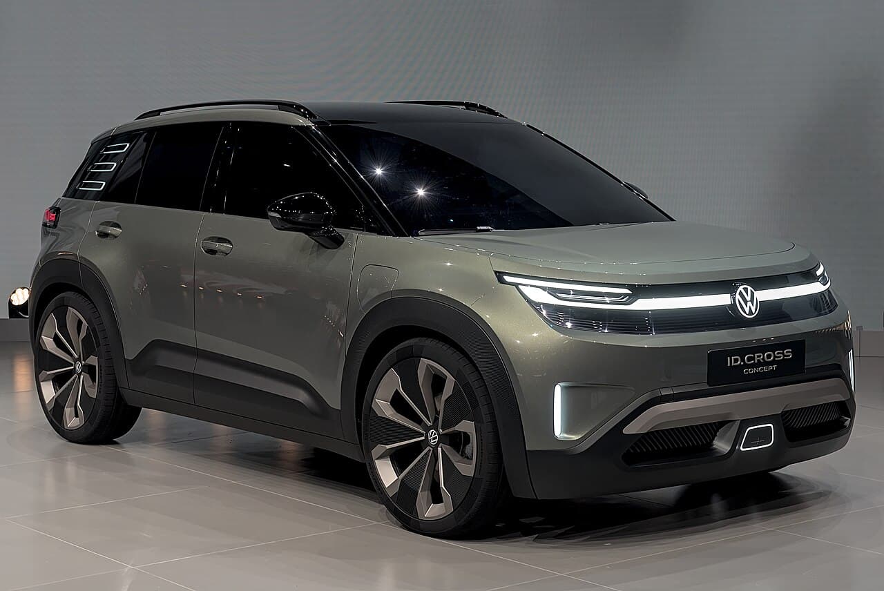 Olive-green Volkswagen ID. Cross concept SUV in a studio, front three-quarter view, plate reading ID.CROSS CONCEPT