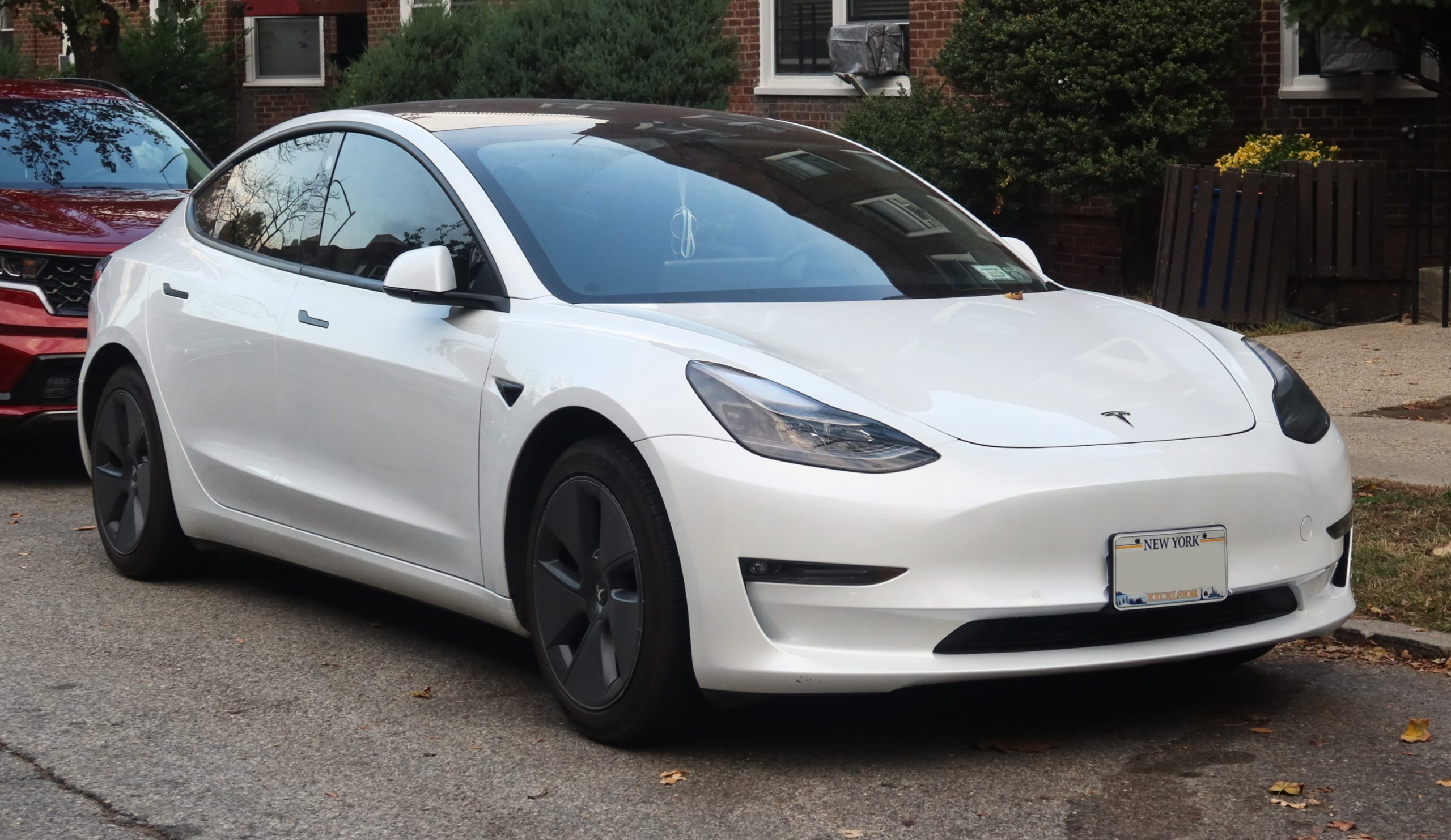 Tesla Model 3 electric sedan at a charging station