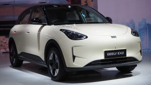 Geely EX2 Max compact electric hatchback, front three-quarter view at a motor show.