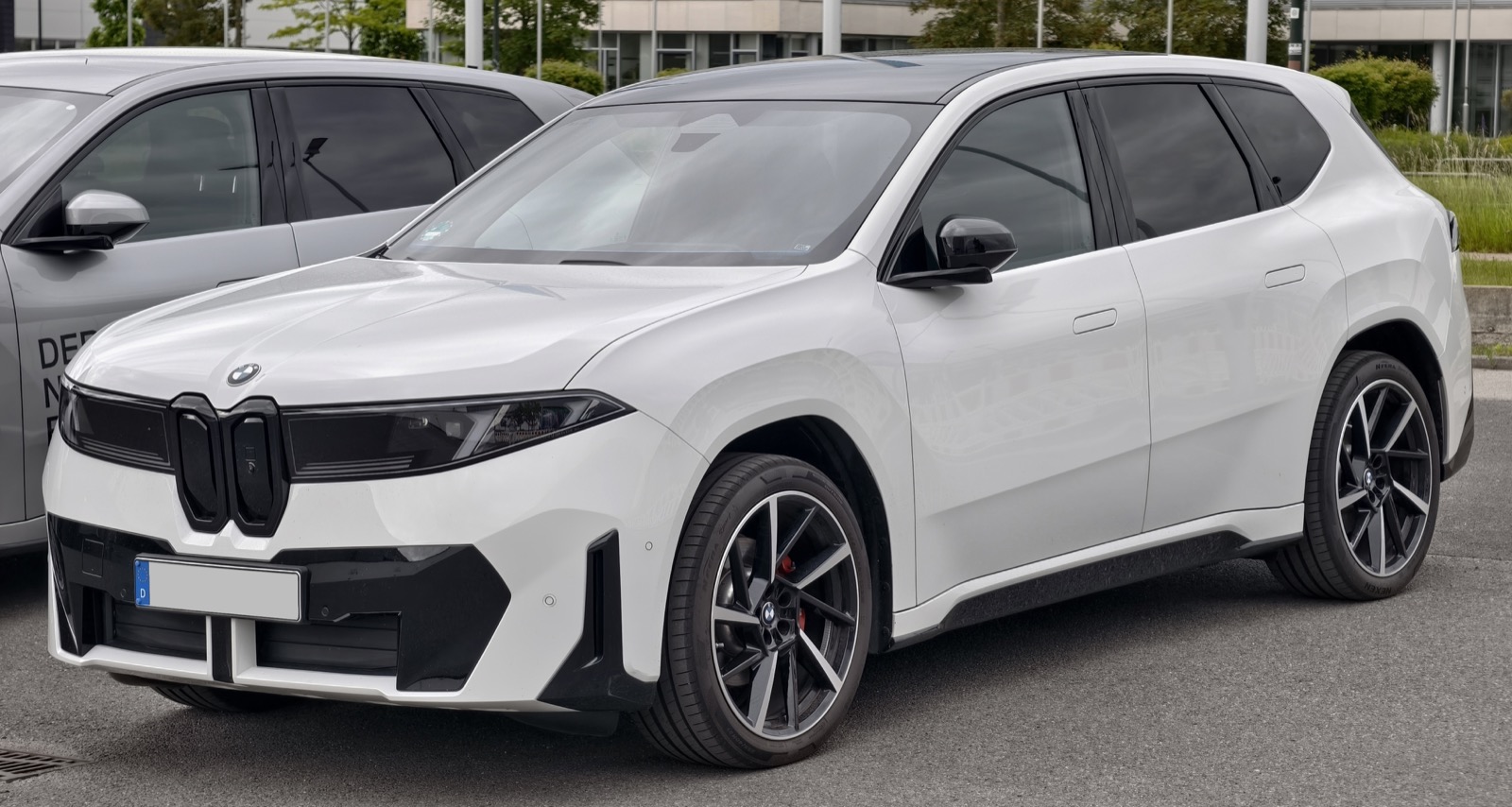 Front three-quarter view of a global-market BMW iX3 50 xDrive M Sport (NA5) electric SUV.