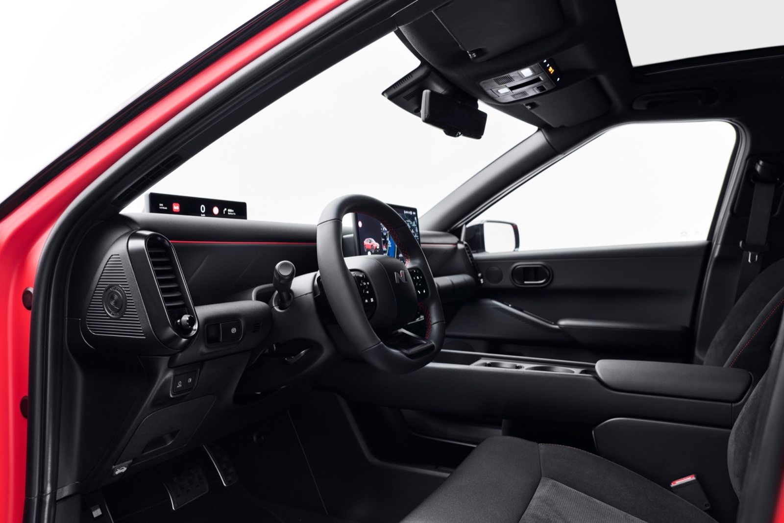 Hyundai IONIQ 3 cabin with wide Pleos Connect touchscreen, official manufacturer press photo
