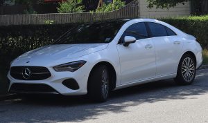 2025 Mercedes-Benz CLA 250 4MATIC sedan in Polar White, front three-quarter, photographed in Newport, Rhode Island — the generation the AMG CLA 45 is built on