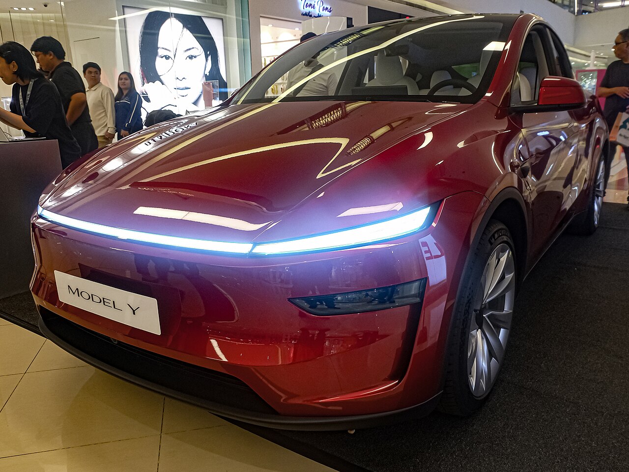 Tesla Model Y Juniper Long Range AWD in Ultra Red, front three-quarter view