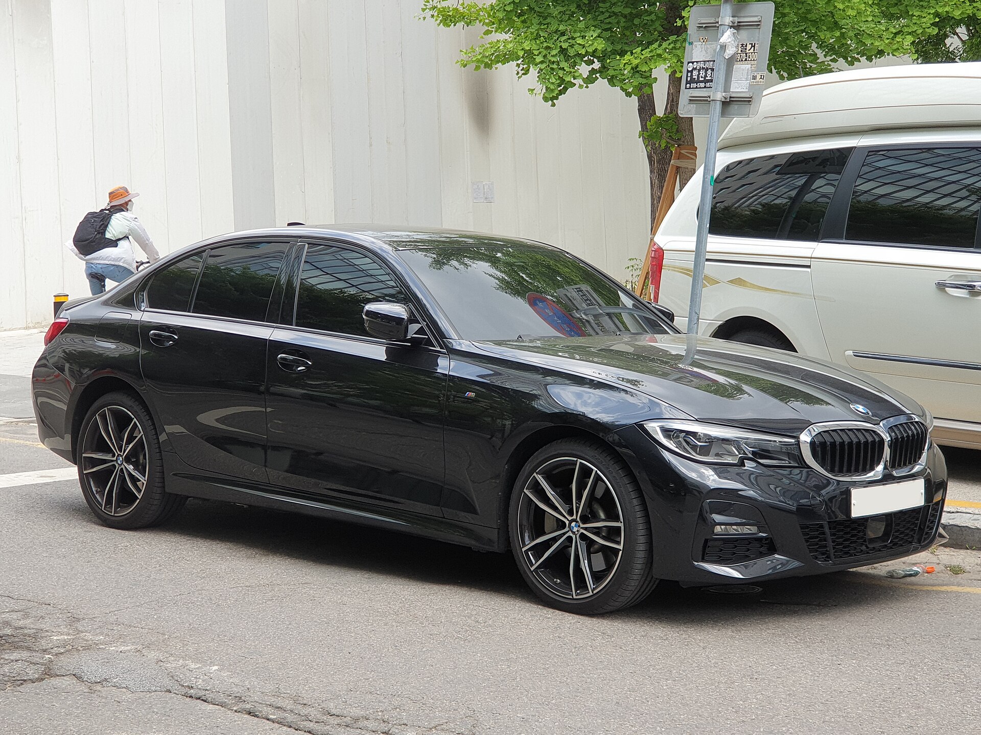 Black BMW G20 330e M Sport plug-in hybrid sedan, front three-quarter view