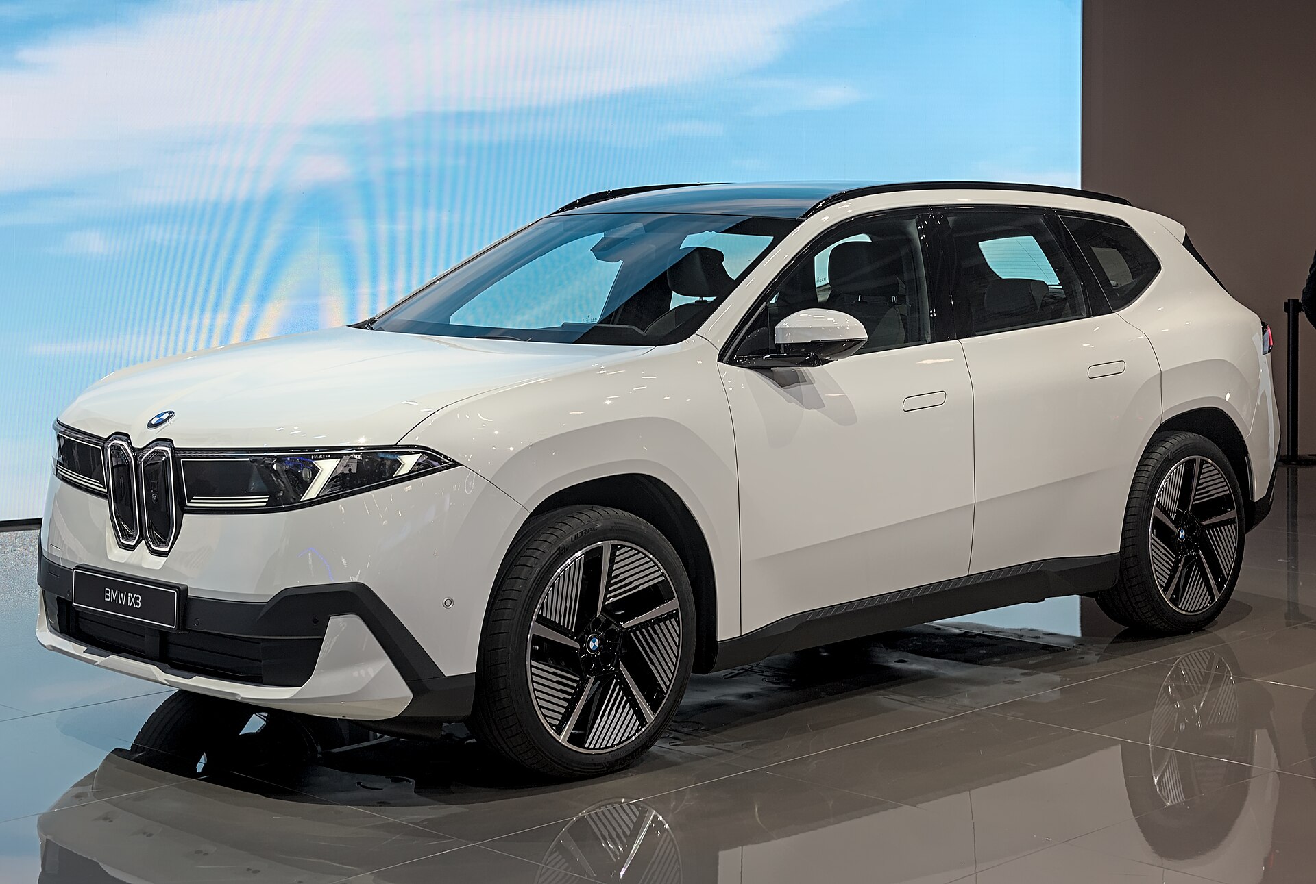 Grey BMW iX3 Neue Klasse battery SUV on the IAA 2025 stand, front three-quarter view