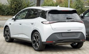 White BYD Dolphin G DM-i plug-in hybrid hatchback seen from the rear, showing the DM-i badge