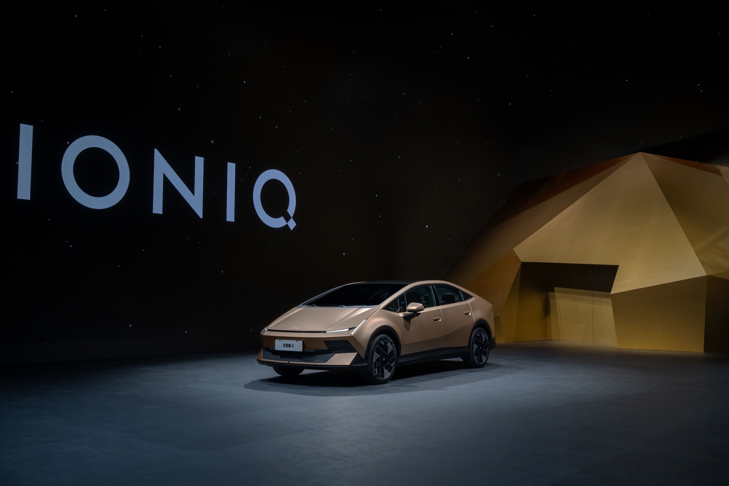 Side view of the gold Hyundai Ioniq V fastback at the Auto China unveil