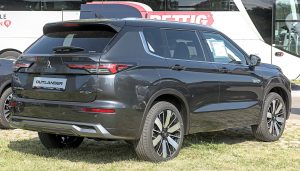 Black 2025 Mitsubishi Outlander plug-in hybrid SUV, front three-quarter view at Automobil Messe Bietigheim