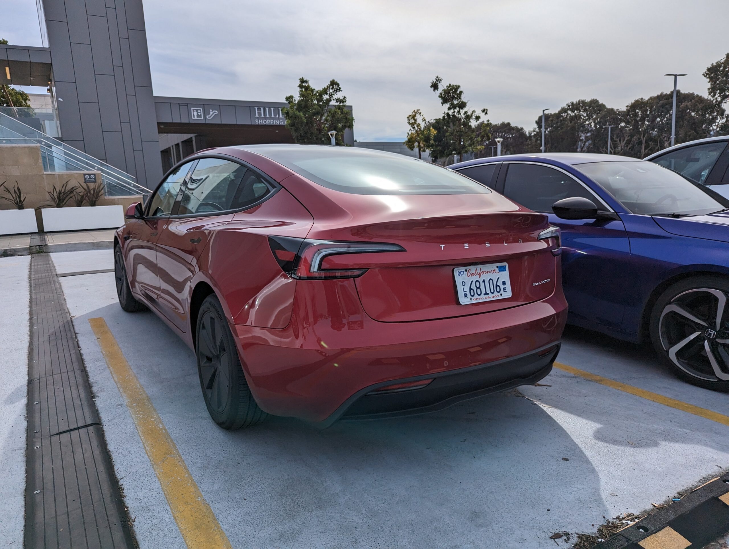 White Tesla Model 3 Highland battery sedan, front three-quarter view