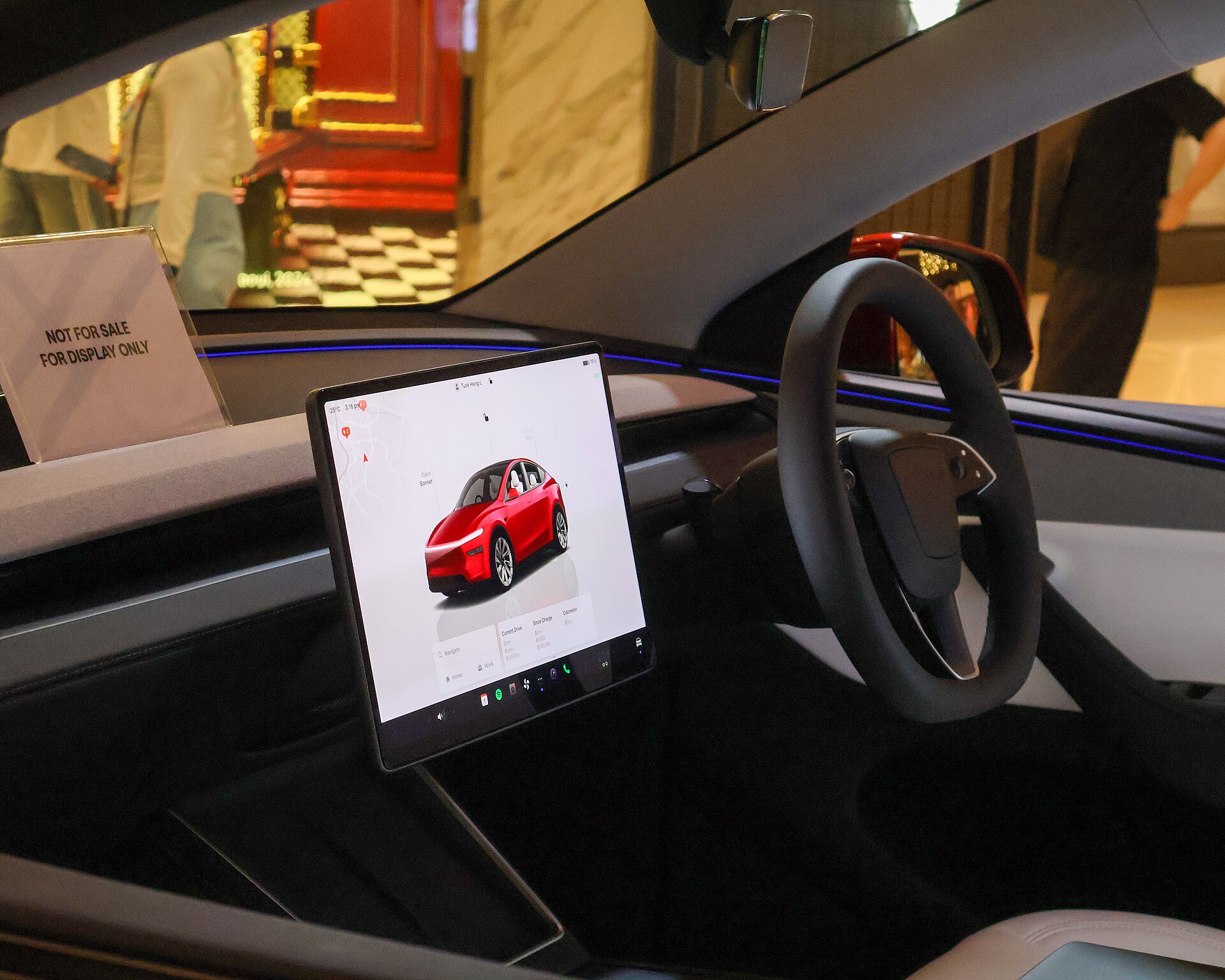 Tesla Model Y cabin with the central touchscreen, photographed in a show car