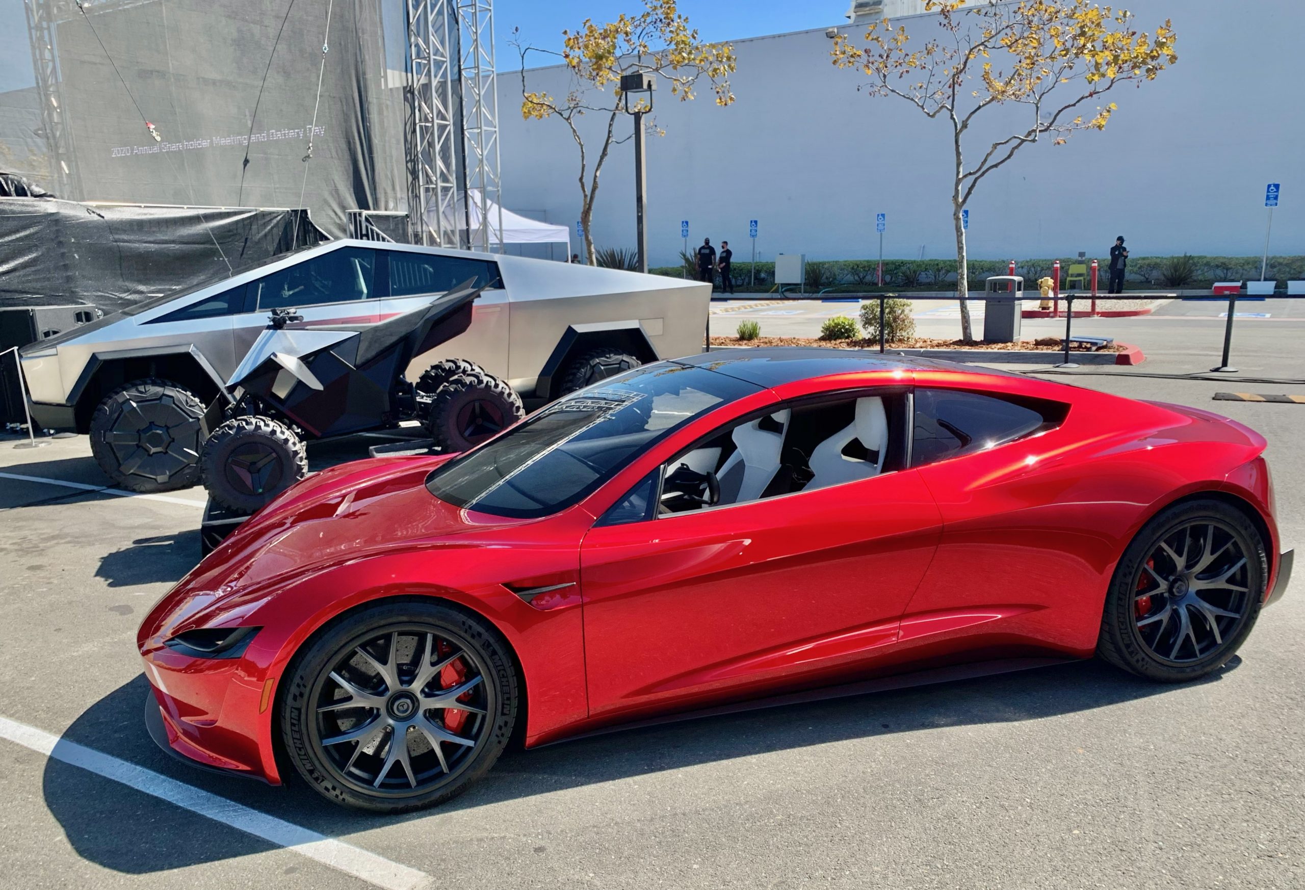 Second-generation Tesla Roadster prototype displayed indoors next to a Tesla Cybertruck at Tesla headquarters in 2020