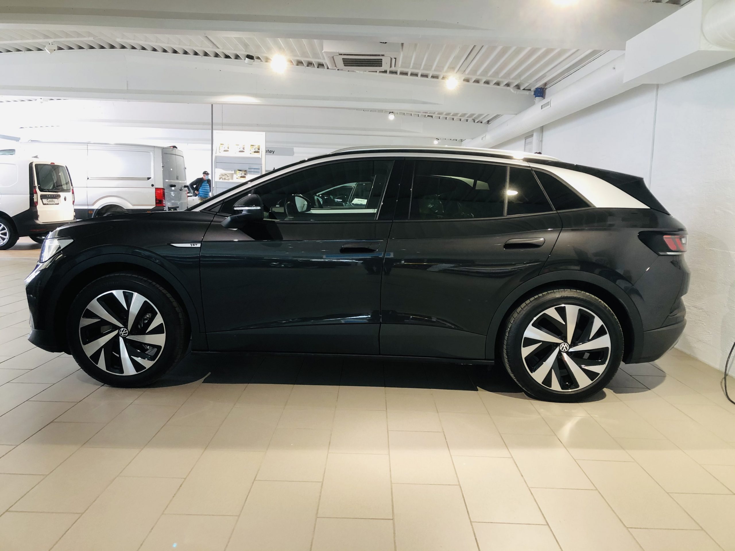 Black Volkswagen ID.4 electric SUV parked, side-front view