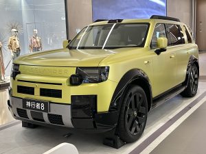 Pale yellow Freelander 8 SUV on a showroom stand, front three-quarter view, FREELANDER lettering across the nose