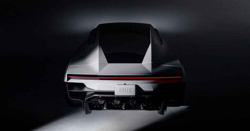 Rear studio view of the Tesla Roadster with a full-width red taillight and four thruster outlets