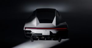 Rear studio view of the Tesla Roadster with a full-width red taillight and four thruster outlets