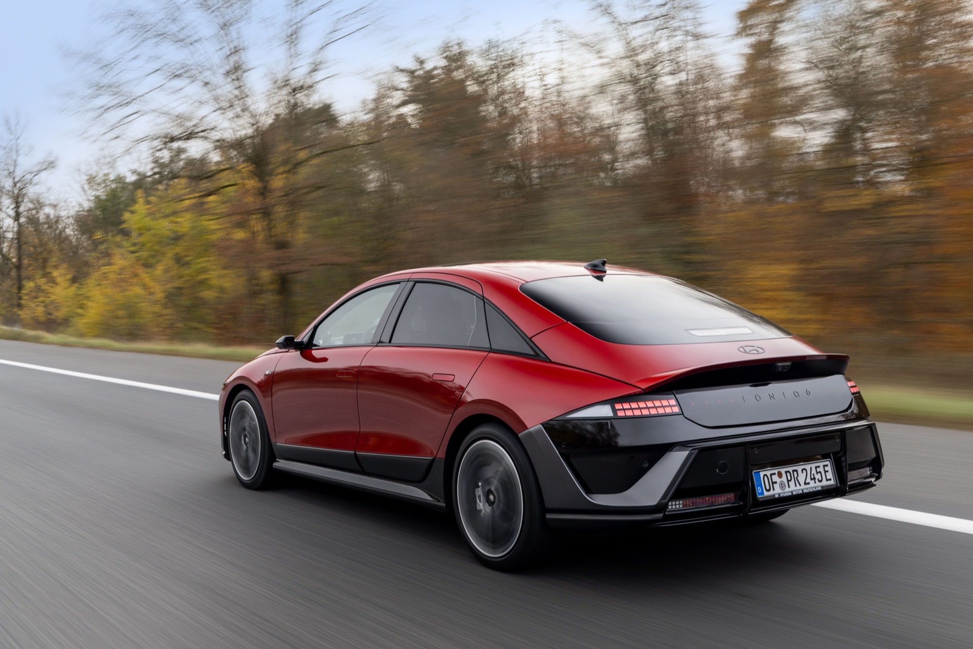 Rear three-quarter view of a red Hyundai IONIQ 6 N Line, with a ducktail spoiler and pixel light bar