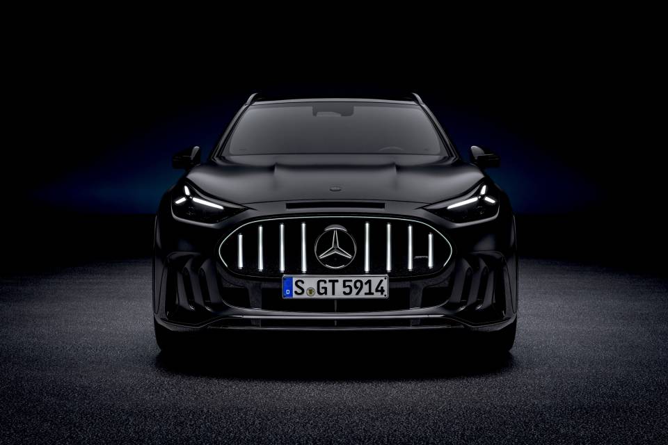 Black Mercedes-AMG GT SUV studio front view with an illuminated grille