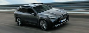 Matte grey Mercedes-AMG GT SUV driving on a highway, front three-quarter view