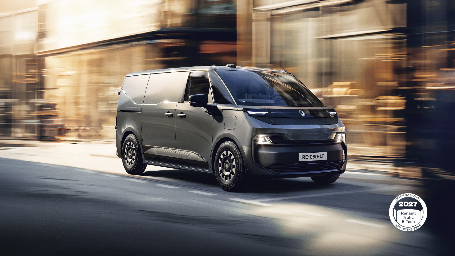 Grey Renault Trafic Van E-Tech electric van driving on a city street
