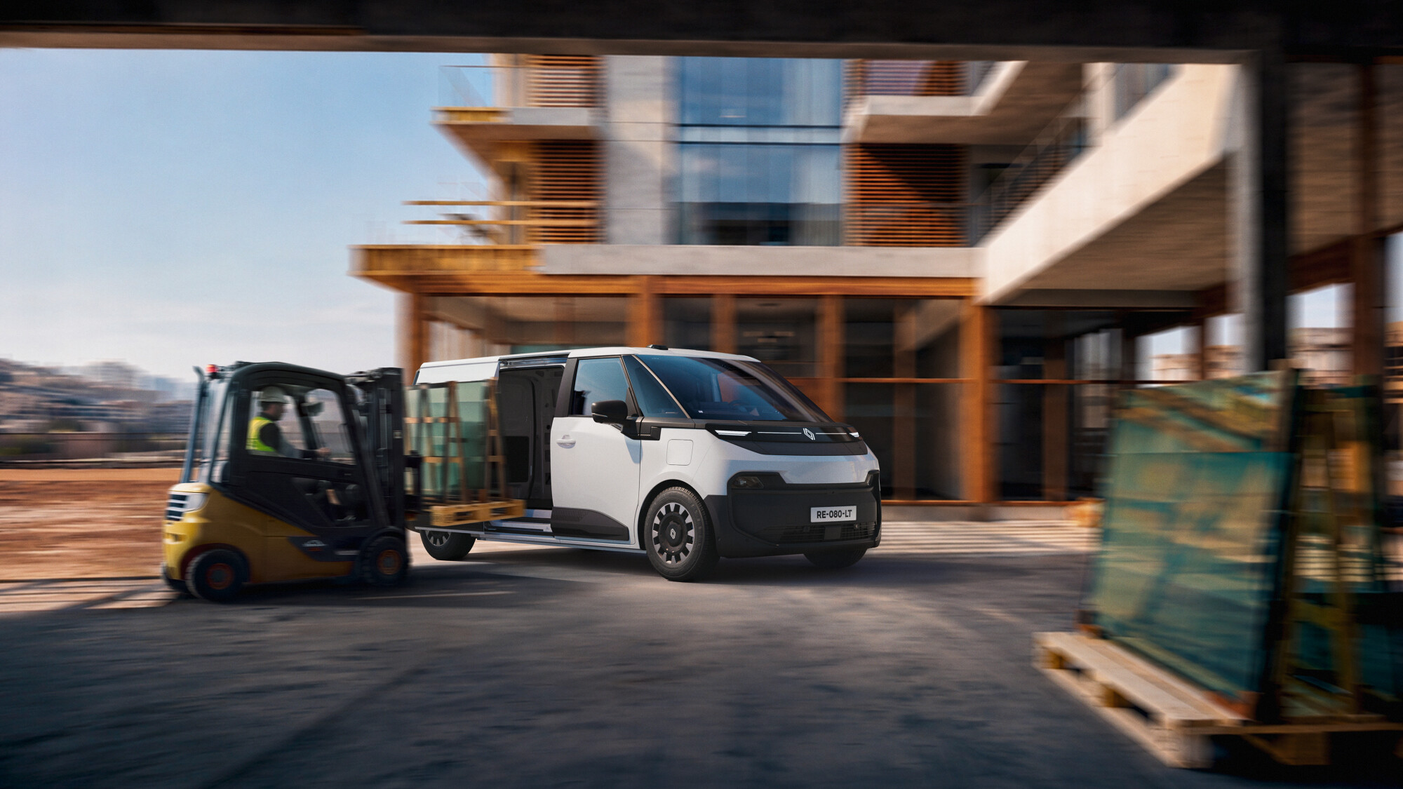 White Renault Trafic Van E-Tech electric van with the sliding side door open at a construction site