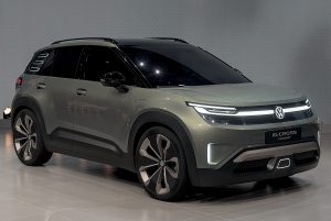 Olive-green Volkswagen ID. Cross concept SUV in a studio, front three-quarter view, plate reading ID.CROSS CONCEPT