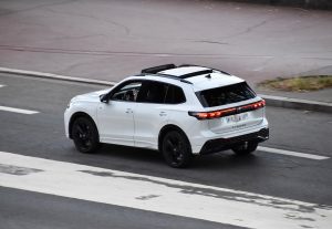 White Volkswagen Tiguan 1.5 eHybrid plug-in hybrid SUV, rear three-quarter view